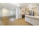 Bright kitchen with stainless steel appliances, laminate floors, light cabinets, and breakfast bar at 10222 N 105Th Dr, Sun City, AZ 85351