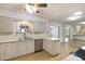 Kitchen with stainless steel appliances, laminate floors, and ample countertop space at 10222 N 105Th Dr, Sun City, AZ 85351