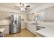 A light-filled kitchen featuring stainless steel appliances and an eat-in bar area at 10222 N 105Th Dr, Sun City, AZ 85351