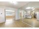 Open-concept living space with adjacent rooms, kitchen and bright natural light from windows at 10222 N 105Th Dr, Sun City, AZ 85351