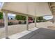 Covered patio area offers outdoor living space with views of the landscaped backyard at 10222 N 105Th Dr, Sun City, AZ 85351