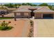 Aerial view of desert home with xeriscaped front, 2-car garage, and covered patio with BBQ at 10535 W San Miguel Ave, Glendale, AZ 85307