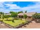 Well-maintained backyard features lush lawn, mature trees, and a covered patio at 10535 W San Miguel Ave, Glendale, AZ 85307