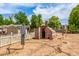 Backyard featuring a shed, scarecrow and an odd outdoor structure behind a white picket fence at 10535 W San Miguel Ave, Glendale, AZ 85307