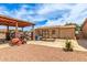 Large backyard shed with covered parking for a boat or RV and a grass lawn at 10535 W San Miguel Ave, Glendale, AZ 85307