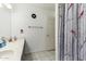 Well-lit bathroom with double sink vanity and decorative cardinal-themed shower curtain at 10535 W San Miguel Ave, Glendale, AZ 85307