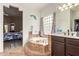 Bathroom with tile flooring, a step-up tub, and a bedroom in the background at 10535 W San Miguel Ave, Glendale, AZ 85307