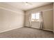 Bright and empty bedroom with neutral carpet and paint and a window at 10535 W San Miguel Ave, Glendale, AZ 85307