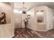 Inviting entryway features hardwood floors, neutral walls, and a decorative chandelier at 10535 W San Miguel Ave, Glendale, AZ 85307