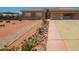 Front yard features brick walkway bordered by rocks and verdant greenery, leading to the home at 10535 W San Miguel Ave, Glendale, AZ 85307