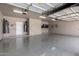This is an oversized garage with epoxy floors and plenty of room for storage and organization at 10535 W San Miguel Ave, Glendale, AZ 85307