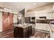 Modern kitchen with an island, stainless steel appliances, and a barn door at 10535 W San Miguel Ave, Glendale, AZ 85307