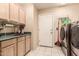 Bright laundry room with washer, dryer, sink, and ample cabinet storage at 10535 W San Miguel Ave, Glendale, AZ 85307