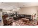 Open-concept living room with hardwood floors, modern furniture, and a view of the kitchen at 10535 W San Miguel Ave, Glendale, AZ 85307