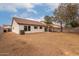 This property boasts a large backyard with trees and a block fence at 10625 E Bramble Ave, Mesa, AZ 85208