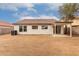 The home has a spacious backyard with a covered patio at 10625 E Bramble Ave, Mesa, AZ 85208