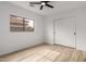 Bright bedroom with light-colored wood-look floors, ceiling fan, and window at 10625 E Bramble Ave, Mesa, AZ 85208