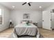 Bright bedroom featuring a ceiling fan, large windows, and stylish decor at 10625 E Bramble Ave, Mesa, AZ 85208