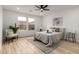 Bright bedroom featuring a ceiling fan, large windows, and stylish decor at 10625 E Bramble Ave, Mesa, AZ 85208