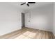 This is a clean and bright bedroom with wood-look floors at 10625 E Bramble Ave, Mesa, AZ 85208
