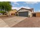 Single-story home with a tile roof,desert landscaping, and a gray garage door, with a spacious driveway at 10625 E Bramble Ave, Mesa, AZ 85208