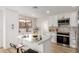 Bright kitchen boasts white cabinets, stainless appliances, backsplash and an island with stylish place settings at 10625 E Bramble Ave, Mesa, AZ 85208