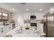 Bright kitchen features white cabinetry, stainless steel appliances, and a marble countertop island at 10625 E Bramble Ave, Mesa, AZ 85208