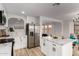 A kitchen featuring white cabinets, stainless steel appliances, an island and an open floorplan at 10625 E Bramble Ave, Mesa, AZ 85208