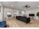 Bright and airy living room featuring an open floor plan, stylish furniture, and hardwood floors at 10625 E Bramble Ave, Mesa, AZ 85208