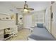 Well-lit bedroom featuring a desk and shelving, tiled floors, and a comfortable-looking bed at 11430 N 109Th St, Scottsdale, AZ 85259