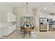 Bright dining area features wainscoting, recessed lights and stainless steel appliances at 11430 N 109Th St, Scottsdale, AZ 85259