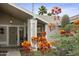 Charming home exterior framed by vibrant desert flowers, offering a glimpse of the welcoming front entrance at 11430 N 109Th St, Scottsdale, AZ 85259