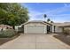 Charming single-story home featuring a neutral color palette, two-car garage and desert landscaping at 11430 N 109Th St, Scottsdale, AZ 85259
