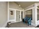 Charming front porch featuring a decorative door, lantern, and a quaint blue bench, creating a welcoming entrance at 11430 N 109Th St, Scottsdale, AZ 85259