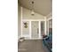 Inviting front porch with a decorated door, overhead light, and a charming blue bench, creating a cozy entryway at 11430 N 109Th St, Scottsdale, AZ 85259