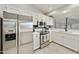 Bright kitchen features white cabinets, stainless steel appliances, and stone countertops at 11430 N 109Th St, Scottsdale, AZ 85259