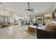 Open floorplan with barstool seating, kitchen, and living area leading to outdoor patio space at 11430 N 109Th St, Scottsdale, AZ 85259