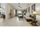 Spacious living room featuring tile floors, a ceiling fan, and comfortable seating area with natural light at 11430 N 109Th St, Scottsdale, AZ 85259