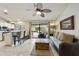 Living area with kitchen, sliding glass doors to outdoor patio, and ceiling fan at 11430 N 109Th St, Scottsdale, AZ 85259