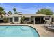Backyard swimming pool with built-in steps, lounge chairs, covered patio with grill, and ample space for outdoor enjoyment at 11430 N 109Th St, Scottsdale, AZ 85259