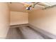 Spacious garage with gray concrete flooring and automatic door at 11500 E Cochise Dr # 2001, Scottsdale, AZ 85259
