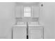 Laundry room with washer and dryer and ample storage space at 11500 E Cochise Dr # 2001, Scottsdale, AZ 85259