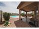 A covered patio overlooks the backyard with a pool, offering an ideal outdoor living space at 11563 W Jefferson St, Avondale, AZ 85323