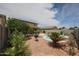 A tranquil backyard featuring a pristine pool, desert landscaping and space for outdoor living at 11563 W Jefferson St, Avondale, AZ 85323