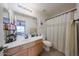 Bathroom featuring a neutral color scheme, functional vanity, and shower with curtain at 11563 W Jefferson St, Avondale, AZ 85323
