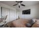 Bedroom featuring neutral colors, comfortable bed, ceiling fan, and closet with doors at 11563 W Jefferson St, Avondale, AZ 85323
