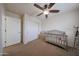 Bright bedroom features a ceiling fan, neutral colors, and a cozy crib; ideal for a Bedroom at 11563 W Jefferson St, Avondale, AZ 85323