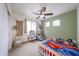 Bedroom featuring kid-friendly design, ceiling fan, and large windows for natural light at 11563 W Jefferson St, Avondale, AZ 85323