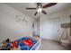Bedroom featuring kid-friendly design, ceiling fan, and closet with sliding doors at 11563 W Jefferson St, Avondale, AZ 85323