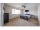 Comfortable bedroom with natural light, ceiling fan, tv, and modern furnishings at 11563 W Jefferson St, Avondale, AZ 85323